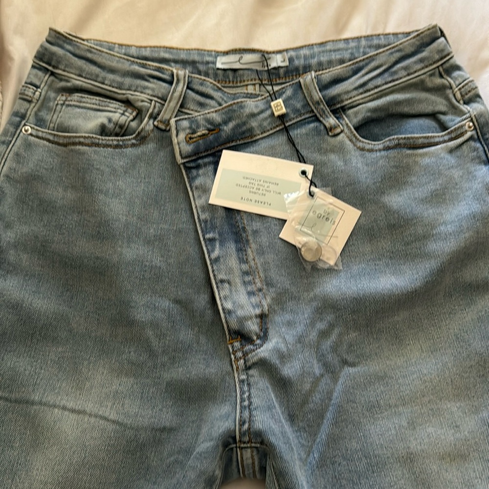 By Egreis. Jeans. Cross over waist.